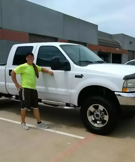 Custom Elite Detail detailer standing beside a freshly washed white Ford truck